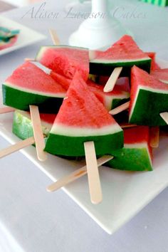 watermelon and lime popsicles are on a white plate with toothpicks