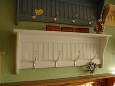 there is a shelf with hooks on it and some decorations hanging from the wall above