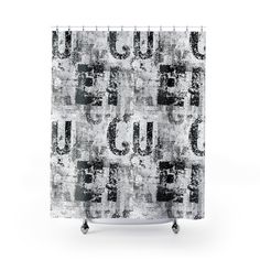 a shower curtain with the word u in black and white letters on an old grungy background