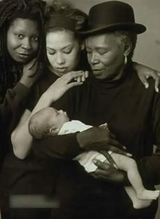 an old black and white photo of three women holding a baby