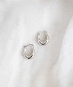 Elevate your style with our minimal Point Huggie Hoops. With a subtle tear-drop silhouette, these huggies are unique enough to feel like an understated statement and versatile for everyday wear. Trust us; you won't want to take them off. Silver Hoop Earrings Aesthetic, Minimal Silver Jewelry, Earring Aesthetic, Earring Stacks, Hoop Earrings Aesthetic, Silver Huggie Earrings, Minimalist Jewelry Silver, Xmas Wishlist, Huggie Earrings Silver