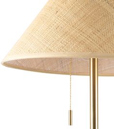 a lamp that is sitting on top of a white surface with a chain hanging from it's side