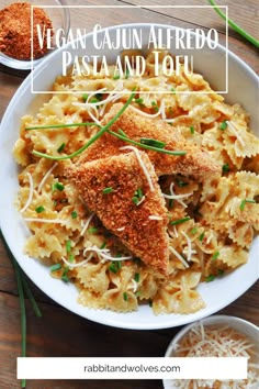 pasta with chicken and parmesan cheese in a white bowl on a wooden table