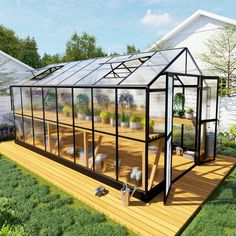 a small greenhouse in the middle of a yard with potted plants and other things