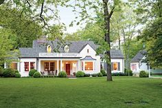 a white house surrounded by trees and grass