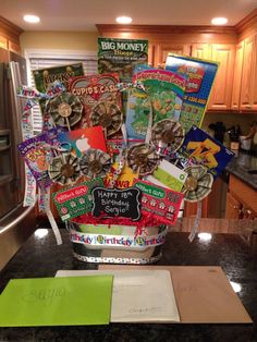 a birthday cake with lots of cards and magnets on it in a kitchen area