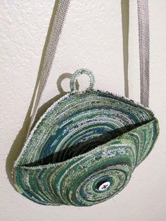 a purse hanging on the wall with a string attached to it's back end