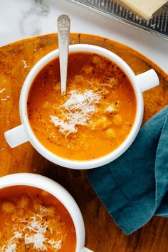 two bowls of soup on a wooden tray