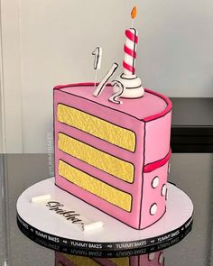 a pink cake with yellow stripes and a candle on top is sitting on a table