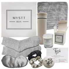 an assortment of items from the mysti box including socks, mittens and candle