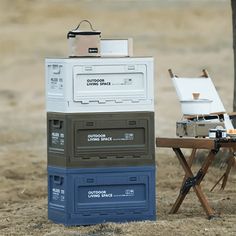 there is a table with two coolers on it and an easel next to it