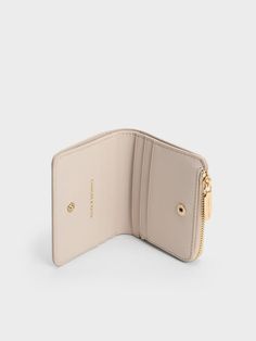 This product is made with at least 20% sustainable materials by weight. CHARLES & KEITH uses recycled, degradable, organic, and water-based materials in our eco-conscious collection. Featuring a soft, soothing colour, this oat wallet will be a beautiful addition to your small accessory collection. With a compact and classic silhouette, it is lightweight and functional. It opens up to a compartmentalised interior that features a note bill section, multiple card slots, as well as a zipped compartment for your coins. The snap-button closure will keep your valuables safe and secure. Elegant Everyday Beige Wallets, Elegant Beige Everyday Wallets, Charles And Keith Mini Wallet, Classic Compact Beige Wallet, Cute Compact Wallet For Daily Use, Belt Ring, Wishlist 2024, Charles Keith, Mini Wallet