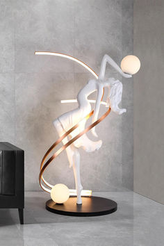 a white sculpture on a black stand next to a chair and lamp in a room