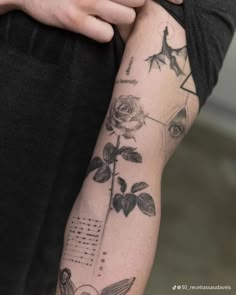 a man's arm with tattoos on it and an image of a rose in the middle