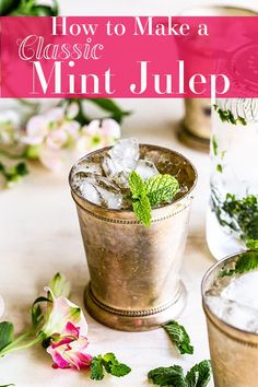 two glasses filled with mint and ice sitting on top of a table next to flowers