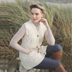 Our Womens Aran Wool Waistcoat is made of 100% Irish Merino Wool, and strikes the perfect balance between tradition and trend. Its 5 button front offers the option to wear the garment open or buttoned. The detailed cable stitching and intricate cable twist gives it that classic Aran feel. Imported from Ireland. Size: L.  Color: Off-White.  Gender: female.  Age Group: adult. Irish Outfits Women, Irish Sweaters Women, Irish Knit Sweaters, Celtic Clothing, Irish Clothing, Irish Sweater, Irish Fashion, Asymmetrical Cardigan, Off White Clothing