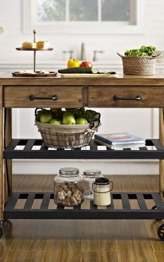 a kitchen cart with food on it in the middle of a wooden floored room