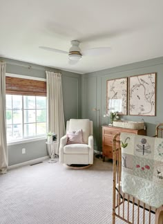 a baby's room with a crib, rocking chair and window in it