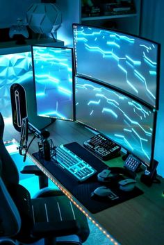 two computer monitors sitting on top of a wooden desk