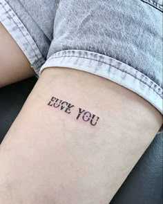 a woman's arm with the words i love you tattooed on her left side