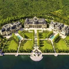 an aerial view of a large mansion on the water's edge, surrounded by lush green trees