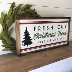 a fresh cut christmas tree sign sitting on top of a shelf