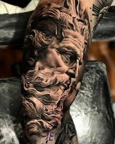 a man's leg with tattoos on it and an image of the face of jesus