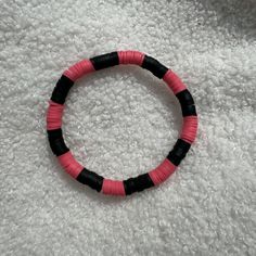 Artisan-crafted bracelet featuring pink and black Heishi clay beads, designed with a stretchy band for easy wear. Size of bracelet in photo: 7 1/2 inches Flat Bead Bracelet Black, Bracelet Perle Plate, Clay Bracelets Ideas, Perle Plate, Ideas For Clay, Clay Bracelets, Clay Bead Bracelet, Bracelets Ideas, Kid Projects