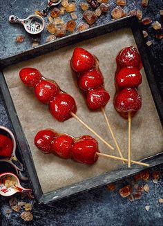 several lollipops are on a tray with toothpicks