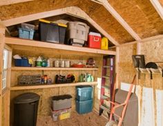 the inside of a shed with shelves and bins