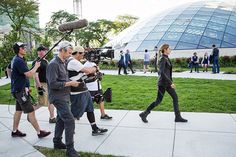 a group of people walking down a sidewalk