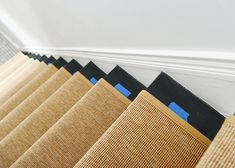 a close up of some blinds on the side of a wall in a room with white walls