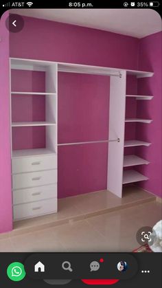 a room with pink walls and white shelves