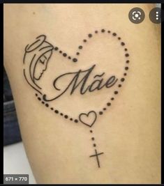 a cross and heart tattoo with the word made written in cursive writing on it