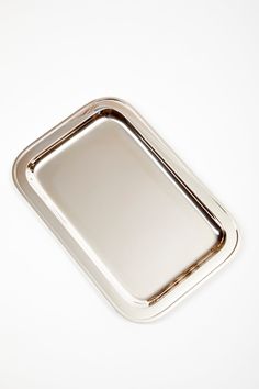 an empty silver tray on a white surface