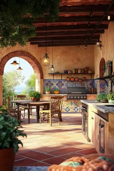 an outdoor kitchen and dining area with potted plants