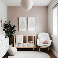 a baby's room with a white crib and two pictures on the wall