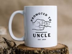 a white coffee mug with the words, promote to uncle on it