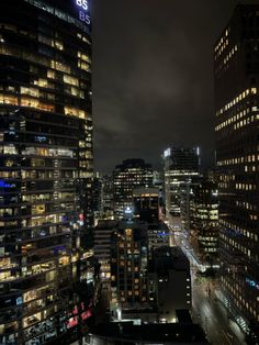 cityscape at night with skyscrapers and street lights