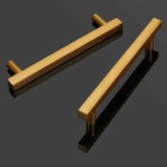 two wooden handles sitting on top of a black surface