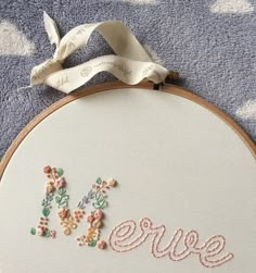 a close up of a embroidery on a piece of cloth with the word errie written in it