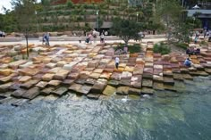 people are standing on rocks in the water near some steps that have been built into them