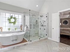 a bathroom with a large bathtub next to a walk in shower