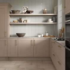 a kitchen filled with lots of counter top space next to a stove and microwave oven