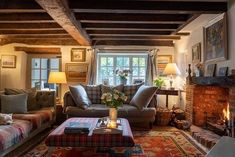 a living room filled with furniture and a fire place