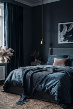 a bedroom with black walls and blue bedding