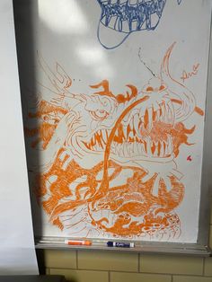 an orange and blue drawing on a white board