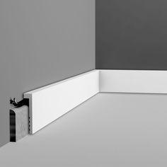 the corner of a room with a black and white photo on it's wall