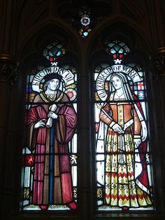 two large stained glass windows in a church