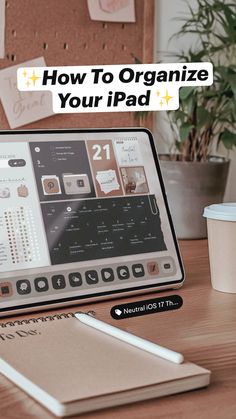 an ipad sitting on top of a wooden table next to a coffee cup and pen